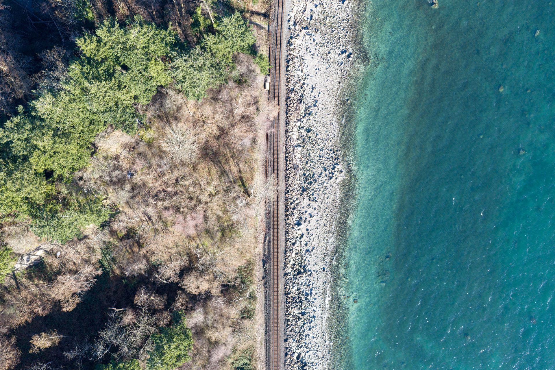 Top down drone view of the beach and the rail line in White Rock
