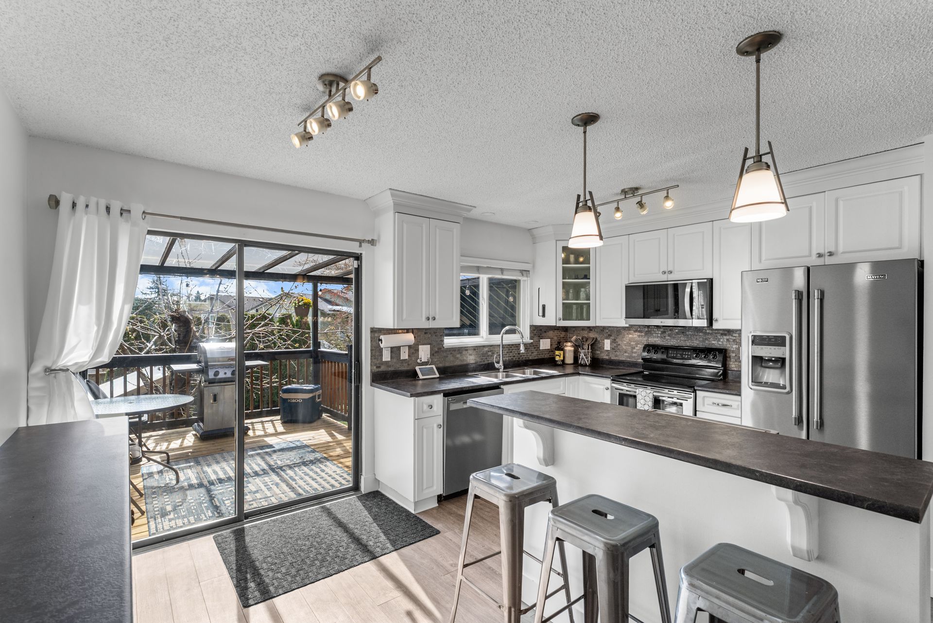 Kitchen with pendant lights and patio doors