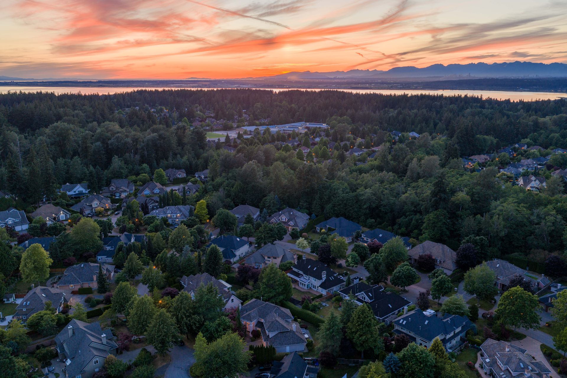 Drone view at sunset over the treed neighbourhood