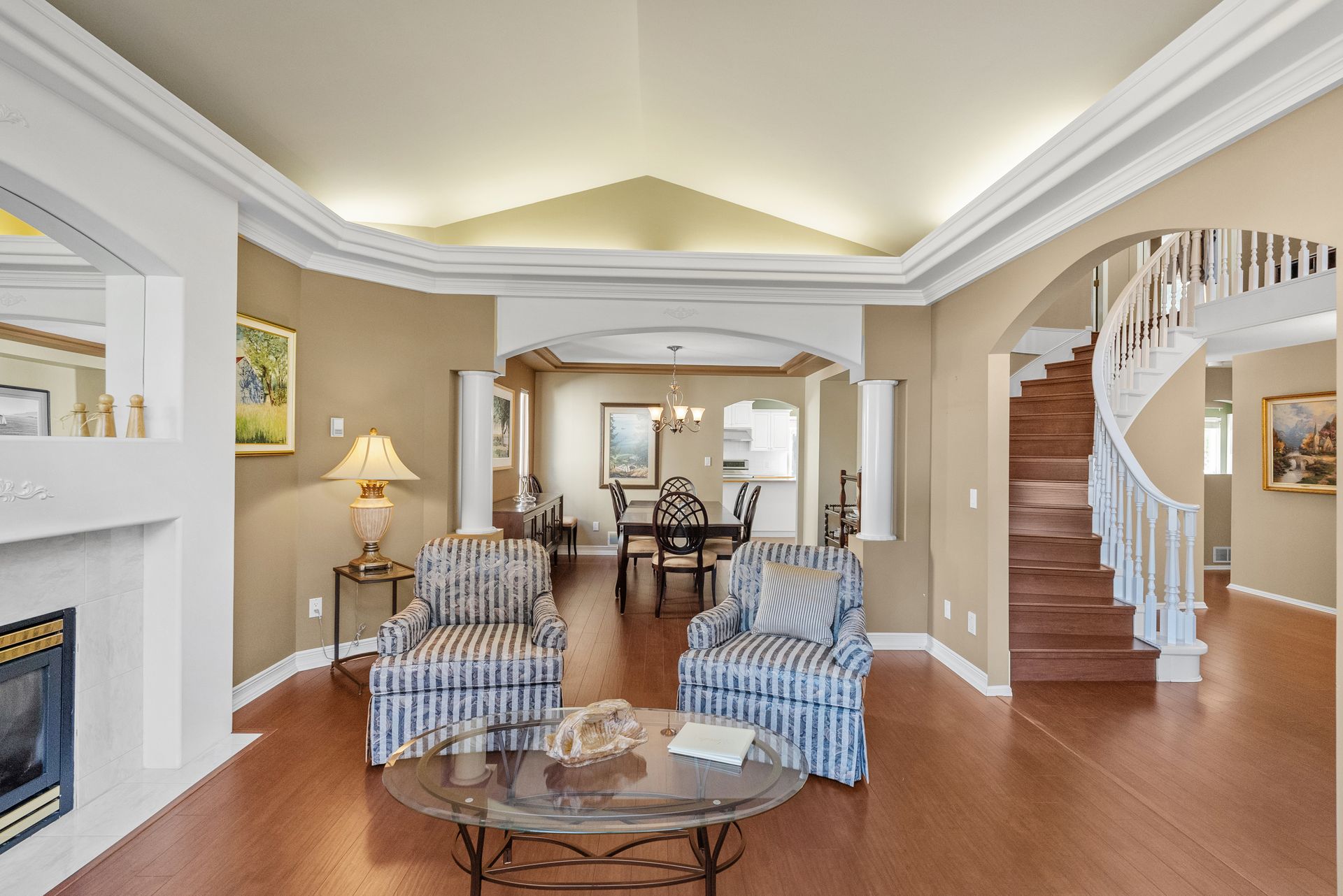 Living room with a curved staircase